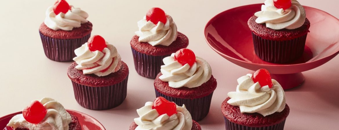 Cherry cupcakes with vanilla buttercream are on the table