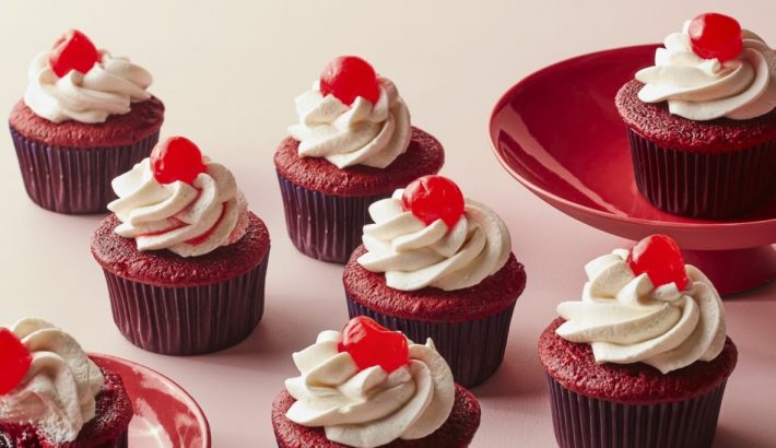 Cherry cupcakes with vanilla buttercream are on the table